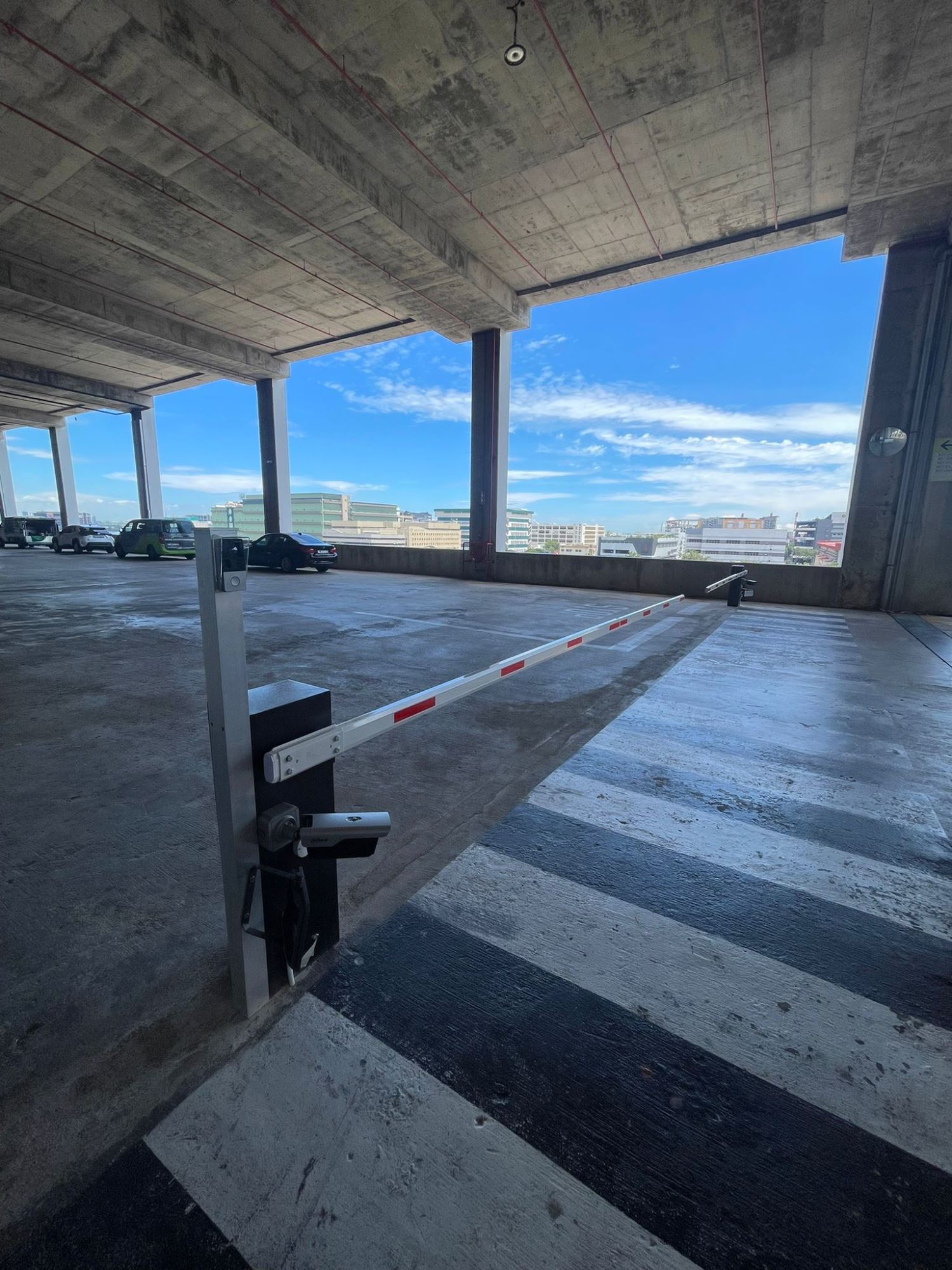 Twin 6 metre barrier arms installed to cover a wide commercial driveway in Singapore
